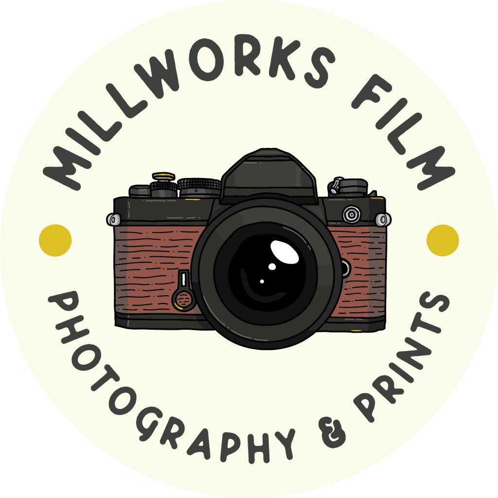 A logo featuring a vintage camera in the center, surrounded by the text Millworks Film at the top and Professional Photography & Prints at the bottom in a circular layout. | Photo by Millworks Film Photography & Prints